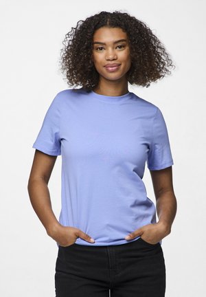 Light purple cotton t-shirt with short sleeves and a crew neck. Smooth texture, featured with hands in pockets and a neutral background.