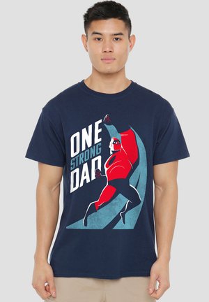 Navy blue cotton t-shirt featuring a bold graphic of a superhero in red with the text "ONE STRONG DAD" in white and light blue accents.