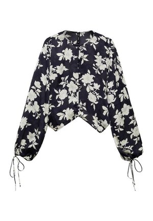 Chemisier floral à manches longues en bleu marine avec des motifs de fleurs blanches. Design cropped, fermeture par boutons et liens réglables aux manches. Tissu doux.