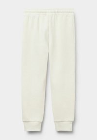 Helle Creme-Sweatpants aus weichem Stoff mit einem elastischen Bund und gerippten Säumen, die eine glatte, einheitliche Textur aufweisen.