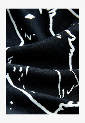 Tessuto nero con una texture morbida caratterizzato da un design astratto bianco. Il motivo comprende contorni e forme sulla superficie.