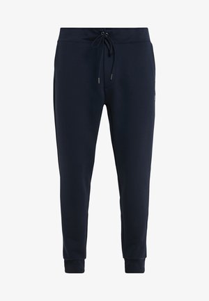 Pantalones deportivos de color azul marino hechos de una suave mezcla de algodón; banda elástica en la cintura con cordón, tobillos ajustados y bolsillos laterales.