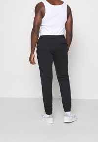 adidas Originals Träningsbyxor - black