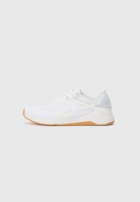 White athletic shoe with a textured upper, accented sides, and a gum rubber outsole. Features laces and a padded collar for comfort.