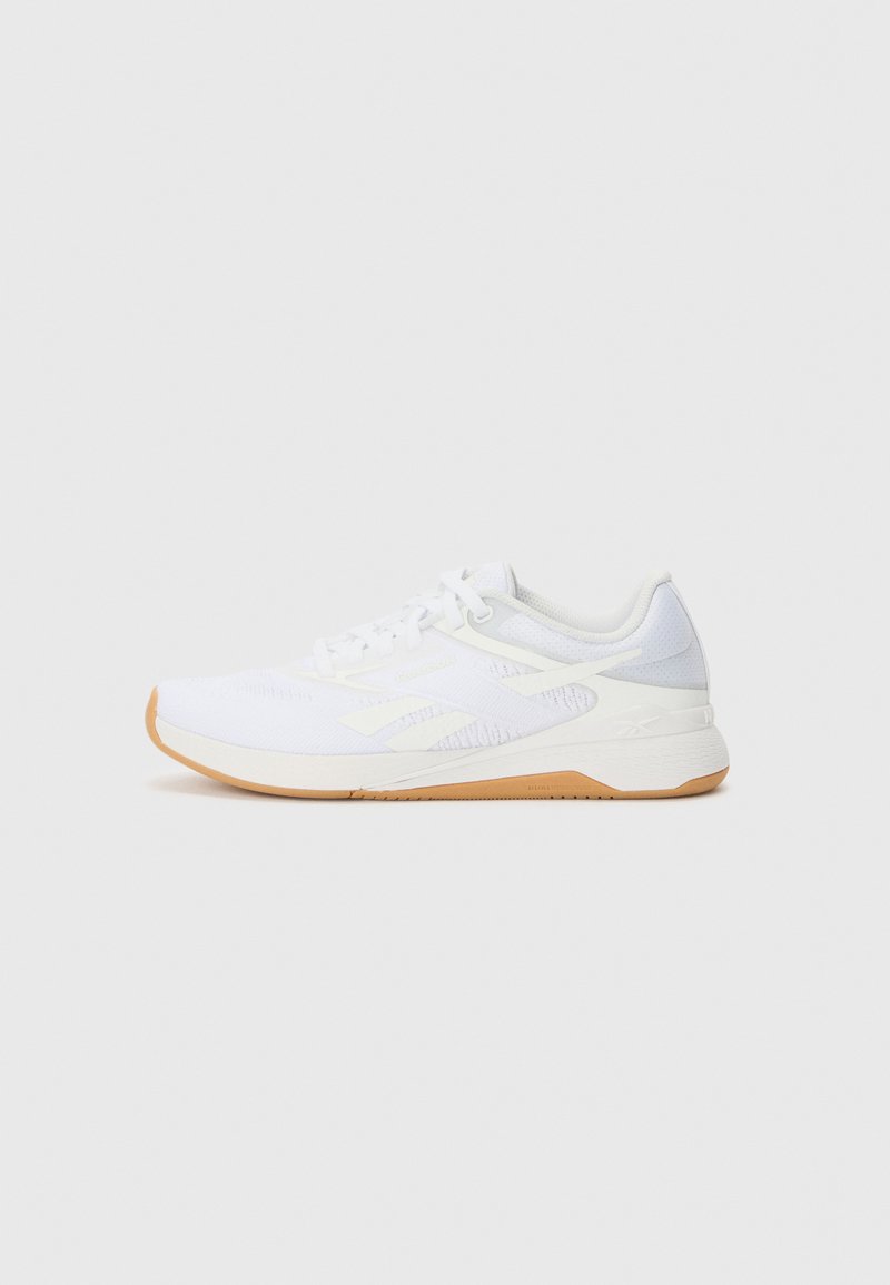 White athletic shoe with a textured upper, accented sides, and a gum rubber outsole. Features laces and a padded collar for comfort.