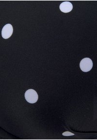 Black fabric with white polka dots, featuring a smooth texture. The design includes evenly spaced, circular patterns.