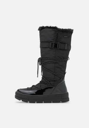 Zwarte winterlaars tot de kuiten met faux fur afwerking, verstelbare zijgesp, gewikkelde veters, glanzende neus en gestructureerde rubberen zool.