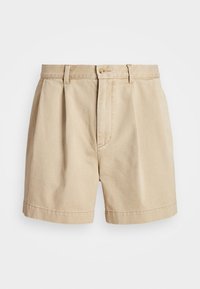 Pantalones cortos beige de algodón, con un frente plisado, cierre de cremallera y botón, y una cinturilla clásica. Textura suave y corte recto.