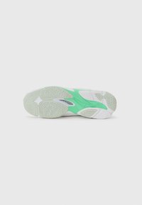 White sneaker sole with a green accent, featuring textured rubber for grip and a unique design with visible branding and patterns.
