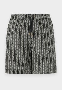 Shorts à motif noir et blanc avec une texture douce, présentant des rayures verticales et des petits motifs floraux, une taille élastique et un cordon de serrage.