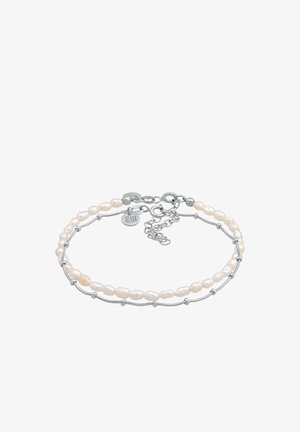 Zilveren armband met onregelmatig gevormde witte zoetwaterparels, voorzien van een sluiting met verlengkettinkje en een klein merktag.