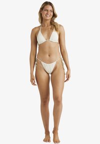 Biały zestaw bikini z trójkątnym stanikiem i regulowanymi majtkami z boku. Miękka tkanina, minimalistyczny design, z delikatnymi metalowymi akcentami.