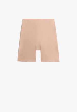 Shorts sculptants beiges avec une texture lisse, présentant une coupe mi-cuisse et un design sans coutures pour un port discret sous les vêtements.