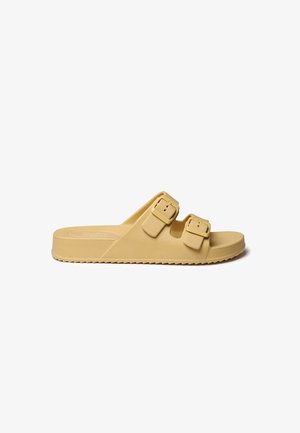 Yellow, synthetic slide sandal with two adjustable buckle straps. Flat sole with textured grip, rounded shape, and minimalistic design.