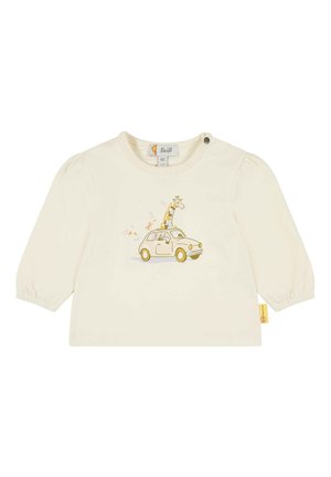 Chemise pour enfants de couleur crème avec des manches bouffantes, ornée d'un graphique de girafe dans une voiture jaune et d'éléments décoratifs colorés.
