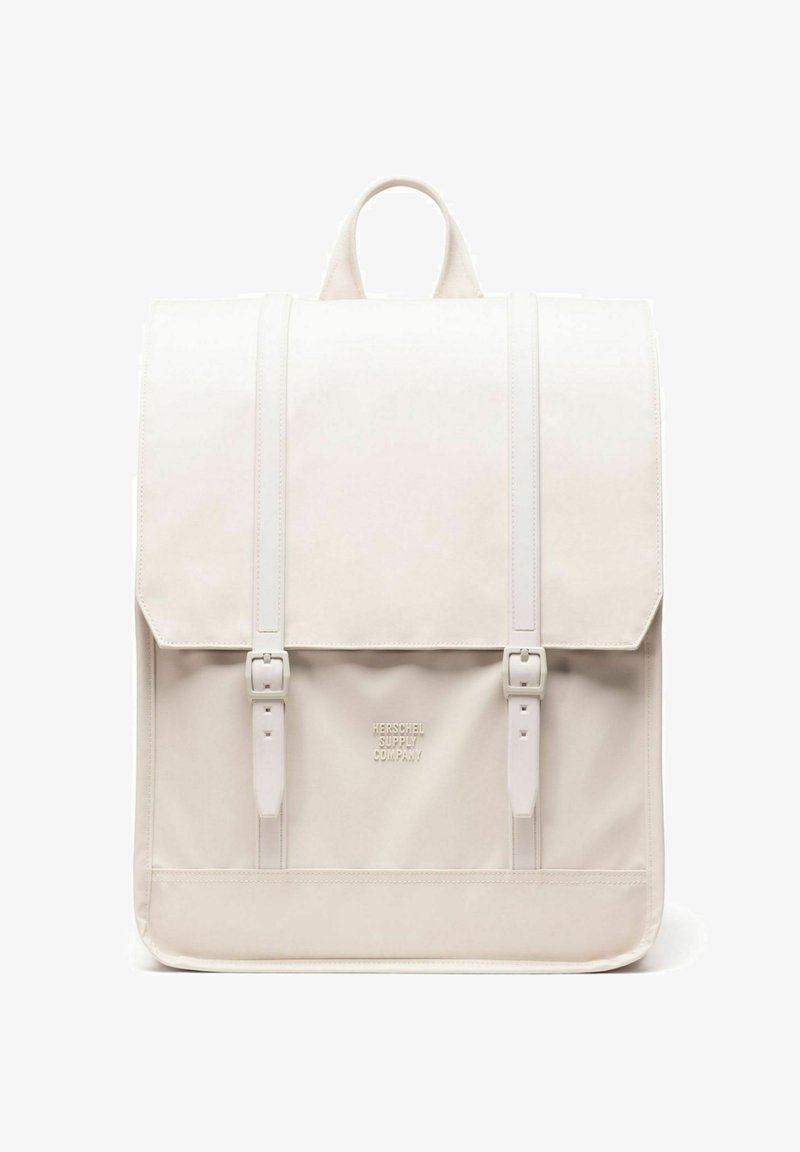 Zaino rettangolare color avorio con manico superiore, due cinturini frontali con fibbia e logo "Herschel Supply Company" sulla tasca frontale.