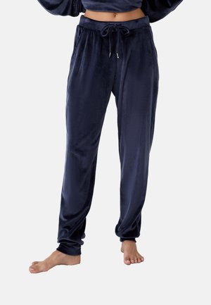 Navyblaue Velourhosen mit elastischem Bund und Kordelzug, die eine entspannte Passform und schmal zulaufende Beine aufweisen, eine glatte Textur haben und keine sichtbaren Muster aufweisen.
