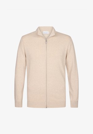 Beige ritsvest gemaakt van zachte stof. Beschikt over een staande kraag en lange mouwen met geribde boorden en onderkant. Eenvoudig, strak ontwerp.