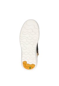 Witte rubberen buitenzool met een getextureerd zigzagpatroon, voorzien van een oranje en groene accent bij de hak. Zwarte boventekstuur zichtbaar.