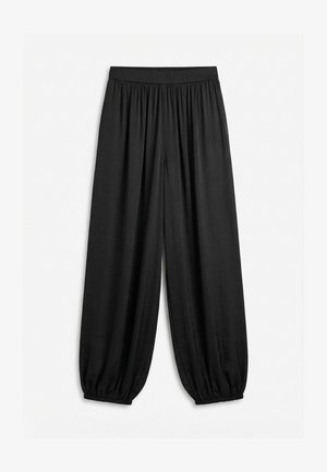 Pantalon noir ample avec taille élastique froncée et poignets élastiques, fabriqué en tissu léger et fluide.