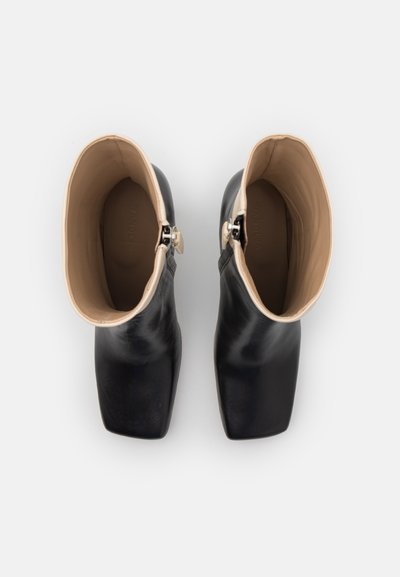 Black leather ankle boots with beige lining, square toe shape, and side zip closure. Smooth texture with minimal detailing.