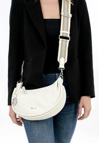 White leather shoulder bag with a curved shape, featuring a patterned strap in cream, gold, and gray. Metal hardware accents included.