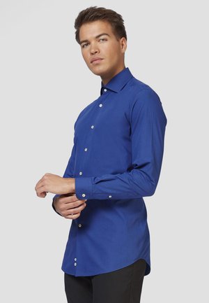 Blue long-sleeve shirt made of smooth fabric, featuring a pointed collar and white button closures along the front and cuffs.