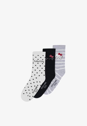 Trois paires de chaussettes en coton : blanches avec des pois noirs, noires avec le visage de Hello Kitty, et rayées grises avec Hello Kitty.
