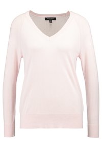Pletený pulovr s výstřihem do V a dlouhými rukávy v jemně růžové barvě; má žebrované manžety a spodní lem, ploché švy podél ramen.
