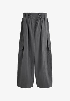 Dark gray wide-leg pants with elastic waistband, drawstring closure, and flap pockets on each side.