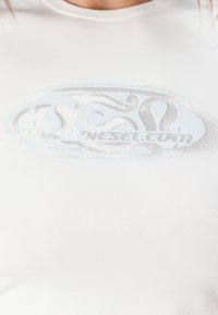 White fitted t-shirt with a smooth texture featuring a large, subtle blue and gray graphic design with the text "www.diesel.com."