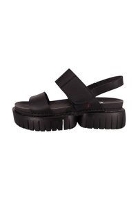 Sandalias negras con una suela gruesa y texturizada, que presentan dos correas anchas sobre el pie y un diseño de talón abierto para un ajuste seguro.