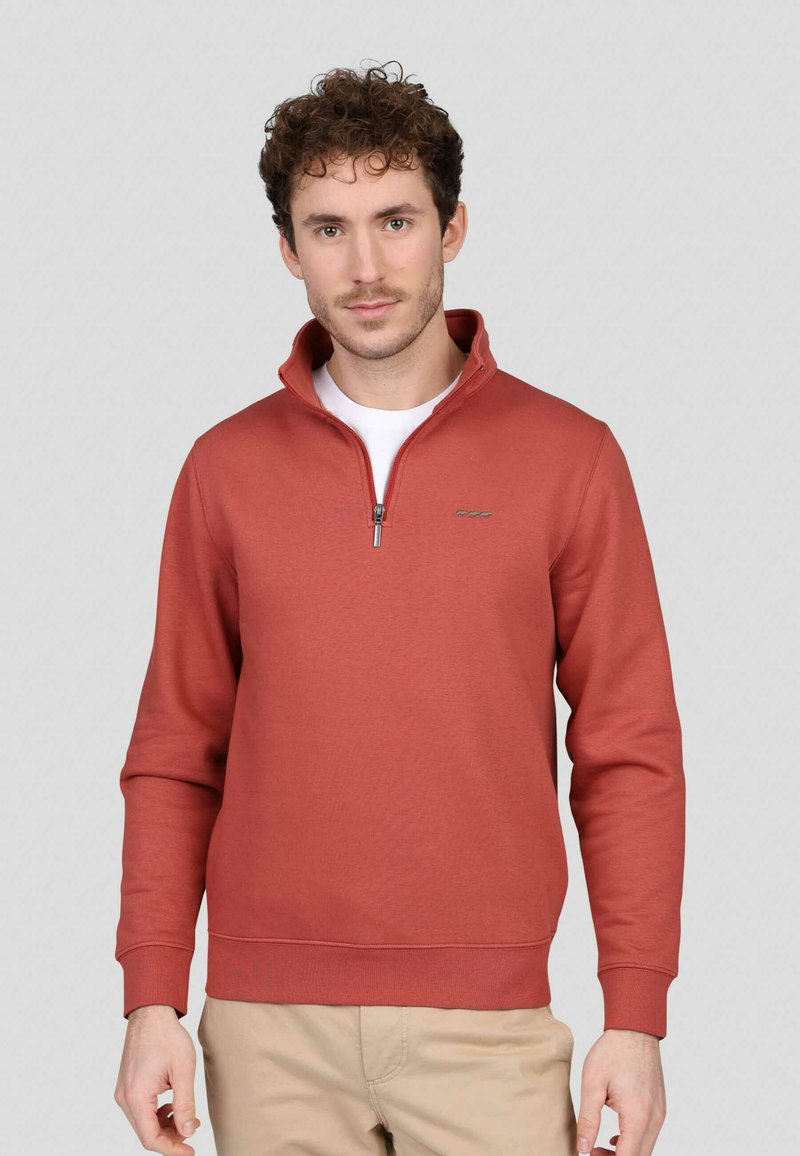 Sweat-shirt zippé rouge en mélange de coton doux, avec un col relevé, des poignets côtelés et un détail de logo sur la poitrine.