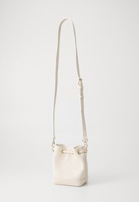 Bucket bag in cream leather with embossed floral patterns, adjustable shoulder strap, and gold-tone hardware. Features drawstring closure.