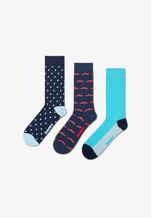 Three pairs of socks: navy with white polka dots, navy with red cars, and a solid turquoise. Each pair features contrasting accents.