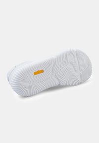 White sneaker sole with textured grooves, featuring a prominent yellow "flotactiv" logo. Smooth finish with curved lines in design.