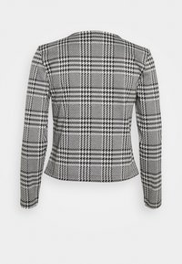Giacca con motivo houndstooth in bianco e nero, maniche lunghe, vestibilità aderente e orlo diritto, realizzata in tessuto testurizzato.