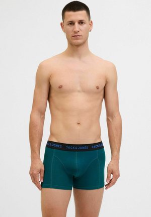 Türkise Boxershorts mit einem dunklen Bündchen, auf dem "JACK & JONES" in blauer Schrift steht, aus einem glatten, dehnbaren Stoff gefertigt.