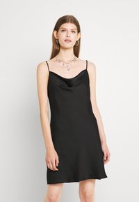 Vestido de cetim preto, com decote drapeado, alças finas e um corte solto. Apresenta uma textura suave e um design minimalista.