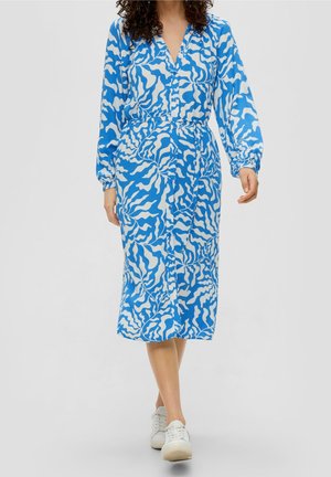 Vestido midi de patrón azul y blanco con mangas largas, escote en forma de V y cintura elástica. La tela parece ligera y fluida.
