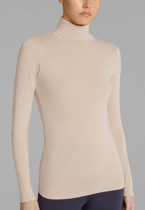 Maglione a manica lunga con colletto alto in beige chiaro, realizzato in un tessuto liscio ed elastico. Design aderente con colletto alto e finitura senza cuciture.