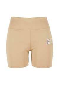 Beige sportieve shorts met een hoge tailleband, gemaakt van rekbaar materiaal. Heeft een wit logo aan de linkerzijde en een gladde textuur.