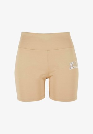 Bežové športové šortky s vysokým pásom, vyrobené zo strečového materiálu. Na ľavej strane majú biele logo a hladkú textúru.