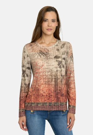 Top de manga larga en beige y óxido con estampado floral y tejido texturizado. Presenta un cuello redondo y un dobladillo decorativo con patrón.