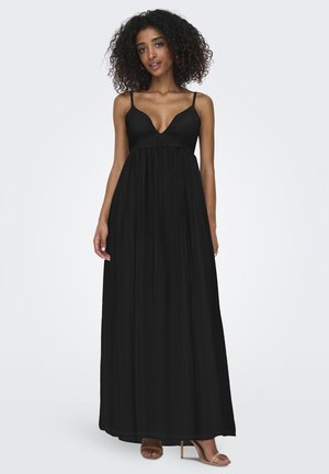 Robe maxi noire avec un décolleté en V plongeant, des bretelles fines et une silhouette ample et fluide. Tissu lisse avec un éclat subtil.