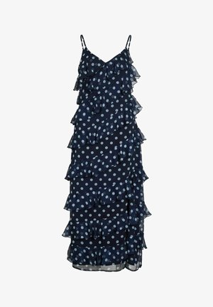 Robe bleu marine sans manches à pois blancs, avec des volants superposés et des bretelles fines.