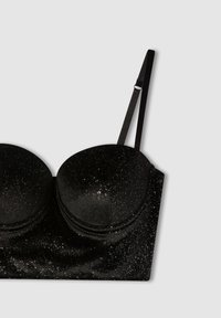 Senza spalline nere con coppe imbottite e strutturate e spalline regolabili, caratterizzata da una texture glitterata con piccole scintille diffuse.
