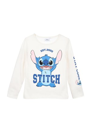 Hvid langærmet skjorte med en stor blå Stitch-figur, teksten "STITCH" og "EST. 2002" foran samt en mindre Stitch-grafik med tekst på ærmet.