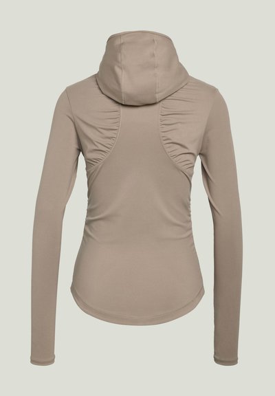 Beige long-sleeve fitted hoodie with ruched seam details on the back and a curved hem, shown from behind.