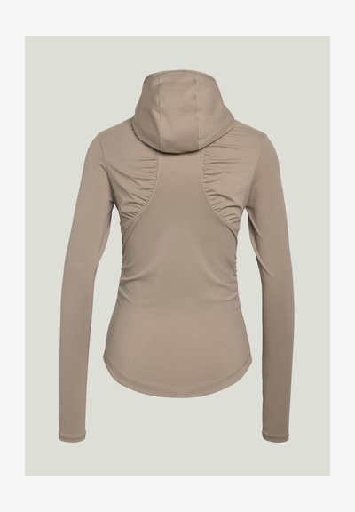 Beige long-sleeve fitted hoodie with ruched seam details on the back and a curved hem, shown from behind.